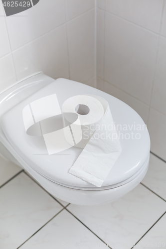 Image of White toilet with toilet paper