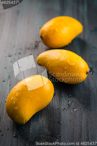 Image of Fresh honey mango fruits on wooden background