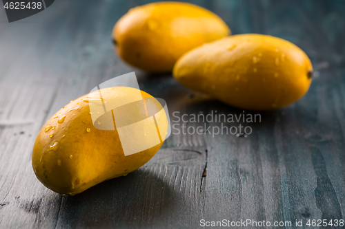 Image of Fresh honey mango fruits on wooden background