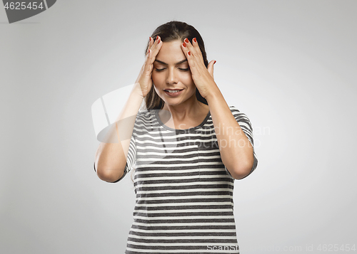 Image of Woman felling a headache