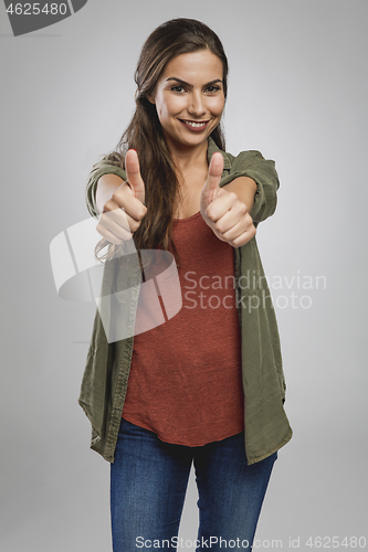 Image of Confident woman with thumbs up