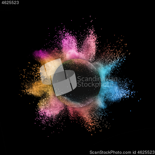 Image of Rainbow powder splash in round frame on a black background.