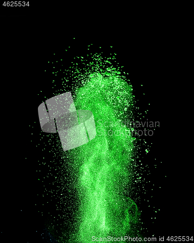 Image of Vertical green powder splash or explosion on a black background.