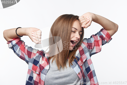 Image of Portrait of a casual teen girl yawning