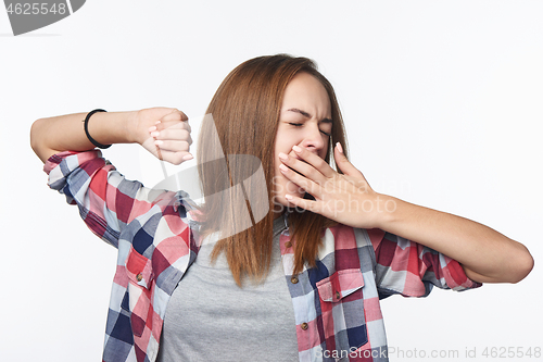 Image of Portrait of a casual teen girl yawning