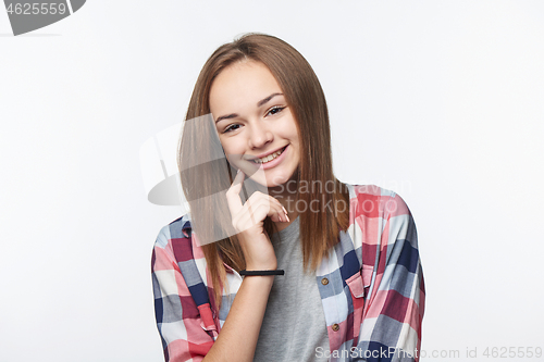 Image of Smiling relaxed teen girl looking at camera