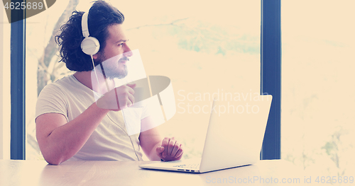 Image of man drinking coffee enjoying relaxing lifestyle