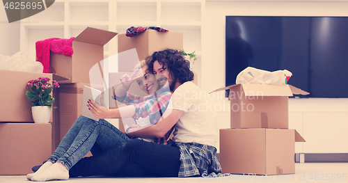 Image of young couple moving  in new house