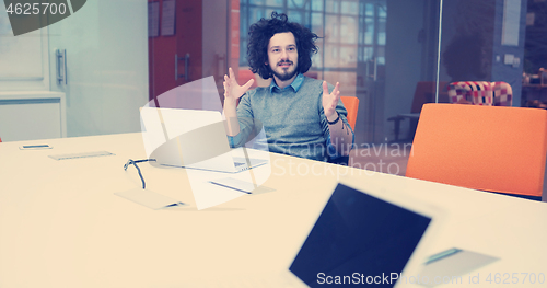 Image of businessman working using a laptop in startup office