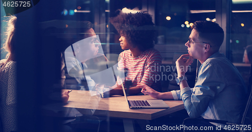 Image of Multiethnic startup business team in night office