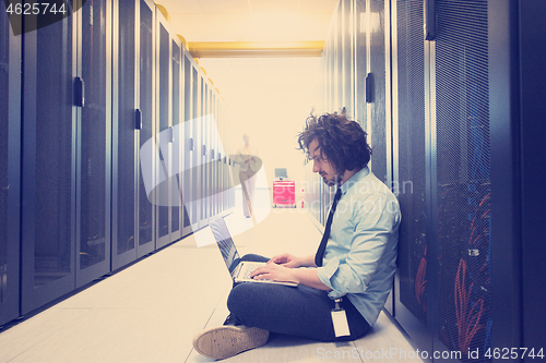 Image of Team of young technicians working together on servers