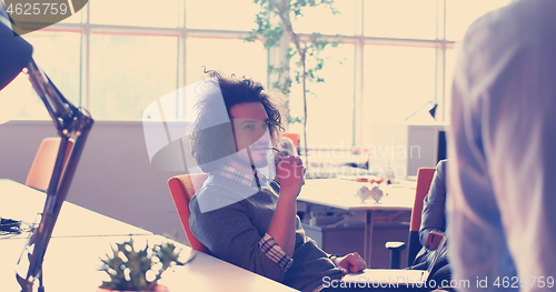 Image of businessman working using a laptop in startup office