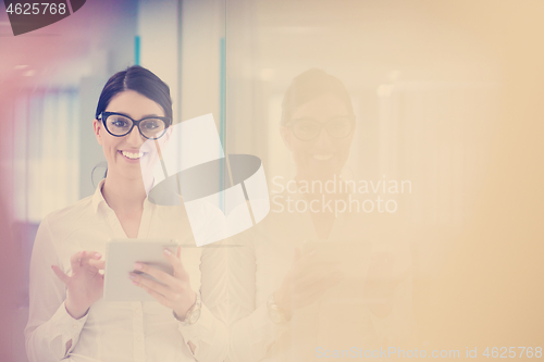 Image of Business Woman Using Digital Tablet in front of startup Office