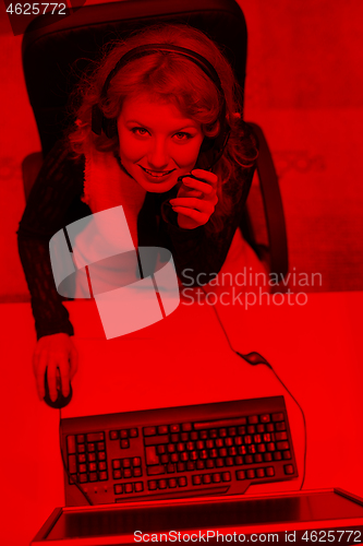 Image of female call centre operator doing her job top view