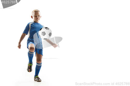 Image of Young boy with soccer ball doing flying kick