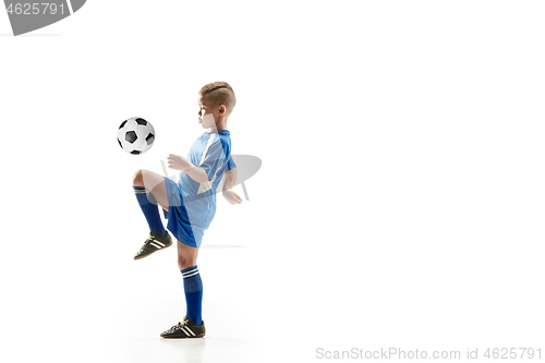 Image of Young boy with soccer ball doing flying kick