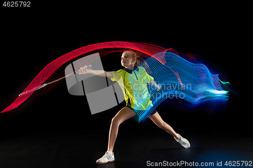 Image of one caucasian young teenager girl woman playing Badminton player on black background