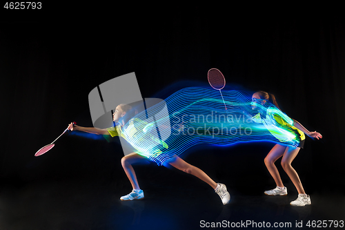Image of one caucasian young teenager girl woman playing Badminton player on black background