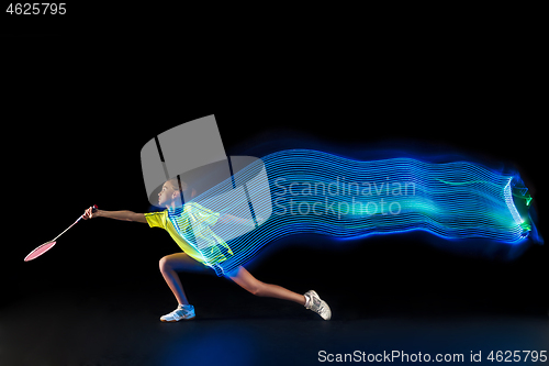 Image of one caucasian young teenager girl woman playing Badminton player on black background