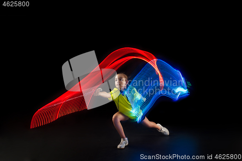 Image of one caucasian young teenager girl woman playing Badminton player on black background