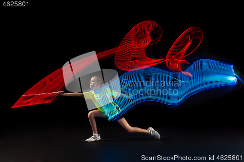 Image of one caucasian young teenager girl woman playing Badminton player on black background