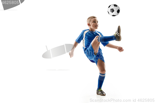 Image of Young boy with soccer ball doing flying kick