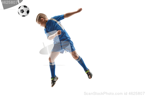 Image of Young boy with soccer ball doing flying kick