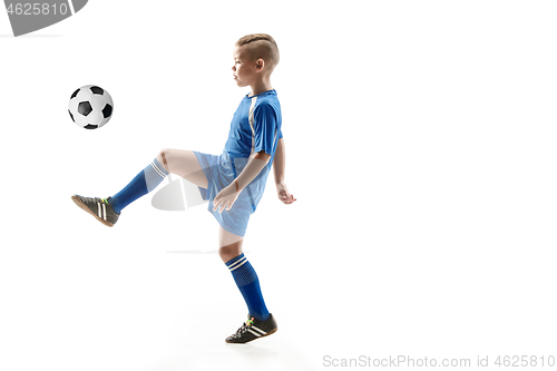 Image of Young boy with soccer ball doing flying kick