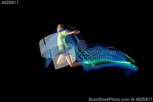 Image of one caucasian young teenager girl woman playing Badminton player on black background