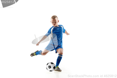 Image of Young boy with soccer ball doing flying kick