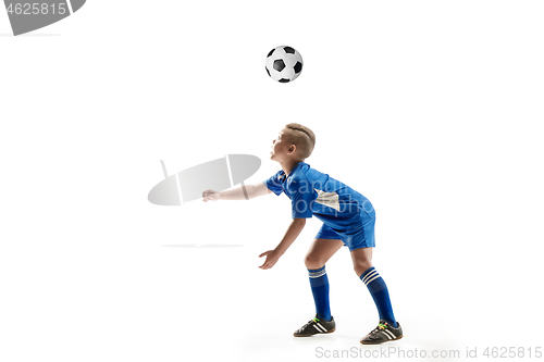 Image of Young boy with soccer ball doing flying kick