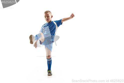 Image of Young boy with soccer ball doing flying kick