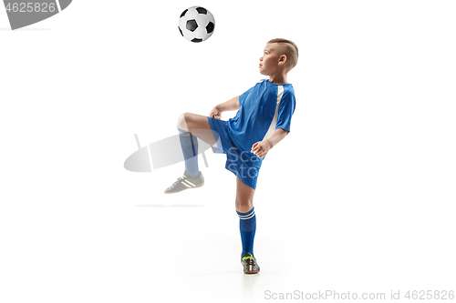 Image of Young boy with soccer ball doing flying kick