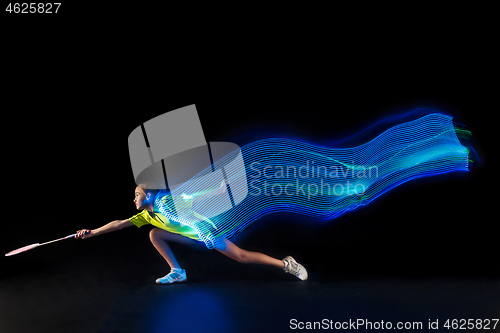 Image of one caucasian young teenager girl woman playing Badminton player on black background