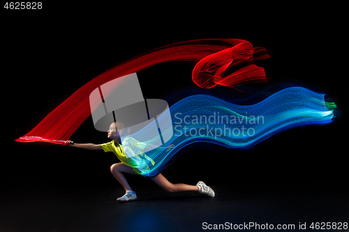 Image of one caucasian young teenager girl woman playing Badminton player on black background