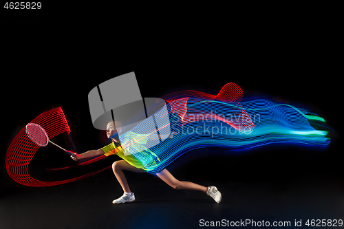 Image of one caucasian young teenager girl woman playing Badminton player on black background