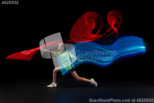 Image of one caucasian young teenager girl woman playing Badminton player on black background