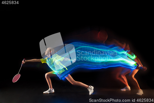 Image of one caucasian young teenager girl woman playing Badminton player on black background