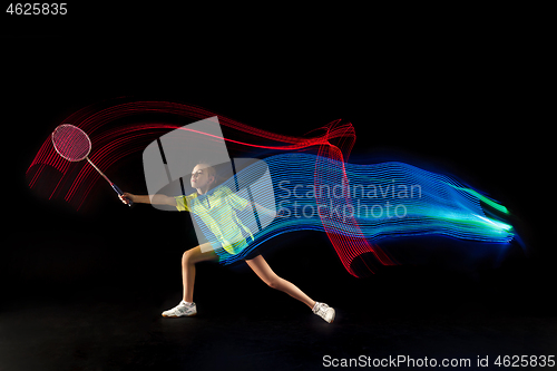 Image of one caucasian young teenager girl woman playing Badminton player on black background