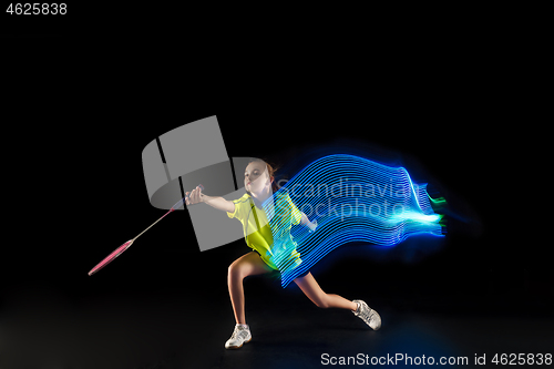 Image of one caucasian young teenager girl woman playing Badminton player on black background