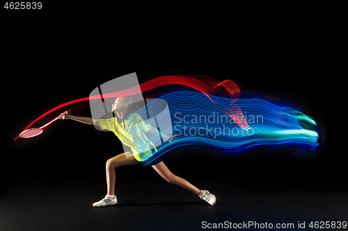 Image of one caucasian young teenager girl woman playing Badminton player on black background