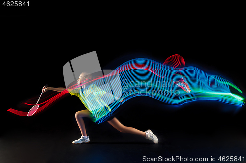 Image of one caucasian young teenager girl woman playing Badminton player on black background