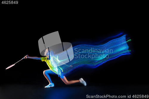 Image of one caucasian young teenager girl woman playing Badminton player on black background