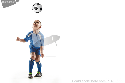 Image of Young boy with soccer ball doing flying kick