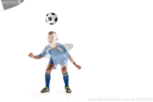 Image of Young boy with soccer ball doing flying kick