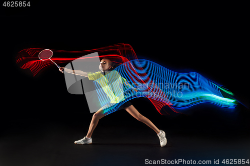 Image of one caucasian young teenager girl woman playing Badminton player on black background