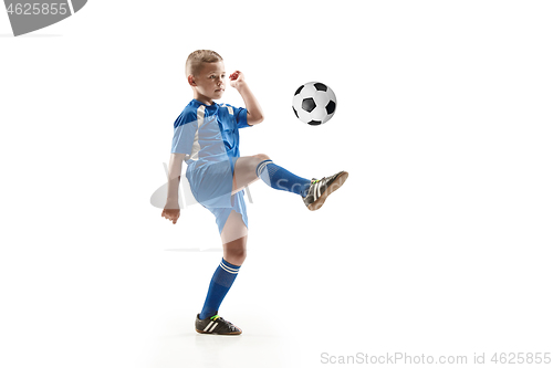 Image of Young boy with soccer ball doing flying kick