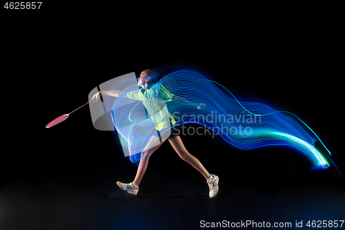 Image of one caucasian young teenager girl woman playing Badminton player on black background