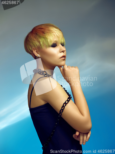 Image of Close-up indoor portrait of lovely girl with blonde hair. Studio shot of graceful young woman with short haircut