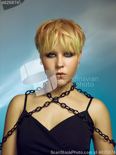 Image of Close-up indoor portrait of lovely girl with blonde hair. Studio shot of graceful young woman with short haircut